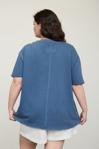 person wearing a blue t-shirt with a white background