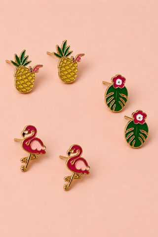 Set of colorful tropical-themed pins including pineapples, flamingos, and cacti on a pink background.
