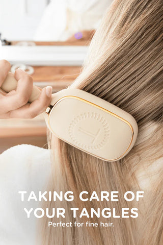 Person using a hair brush on their hair with text 'Taking care of your tangles' and 'Perfect for fine hair.'