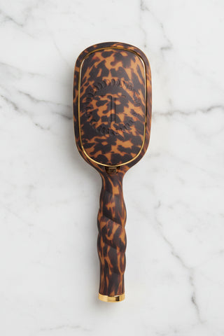 Tortoiseshell patterned hairbrush on a white background