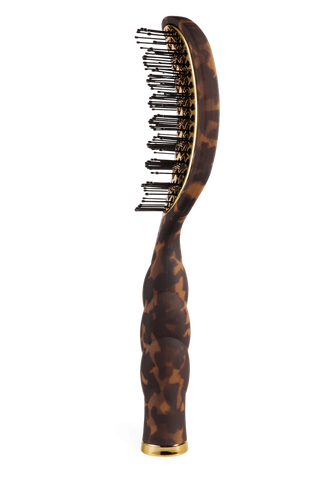 Hairbrush with tortoiseshell handle on a white background
